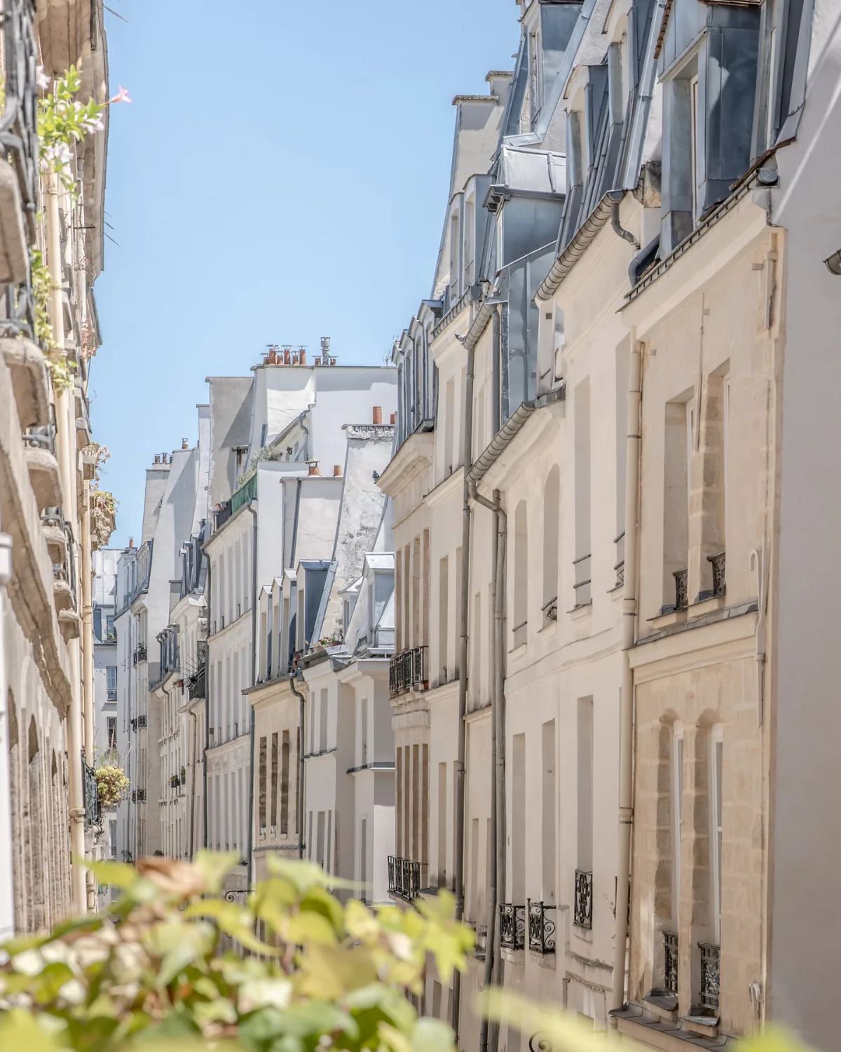 A narrow street receding into the distance, zinc roofs, Paris 2nd arrondissement